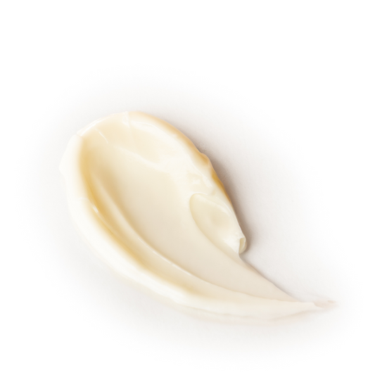 Close-up of a smear of beige cream on a white background