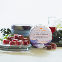 Vital Body sleep gummies on a table with a blurred background