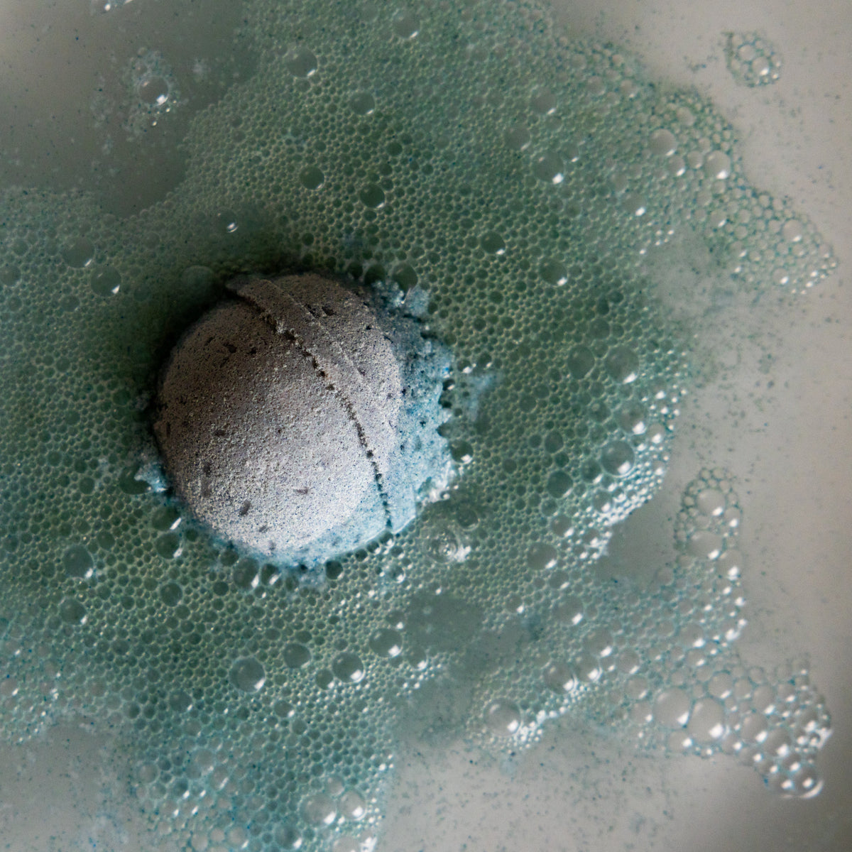 Bath bomb fizzing in water