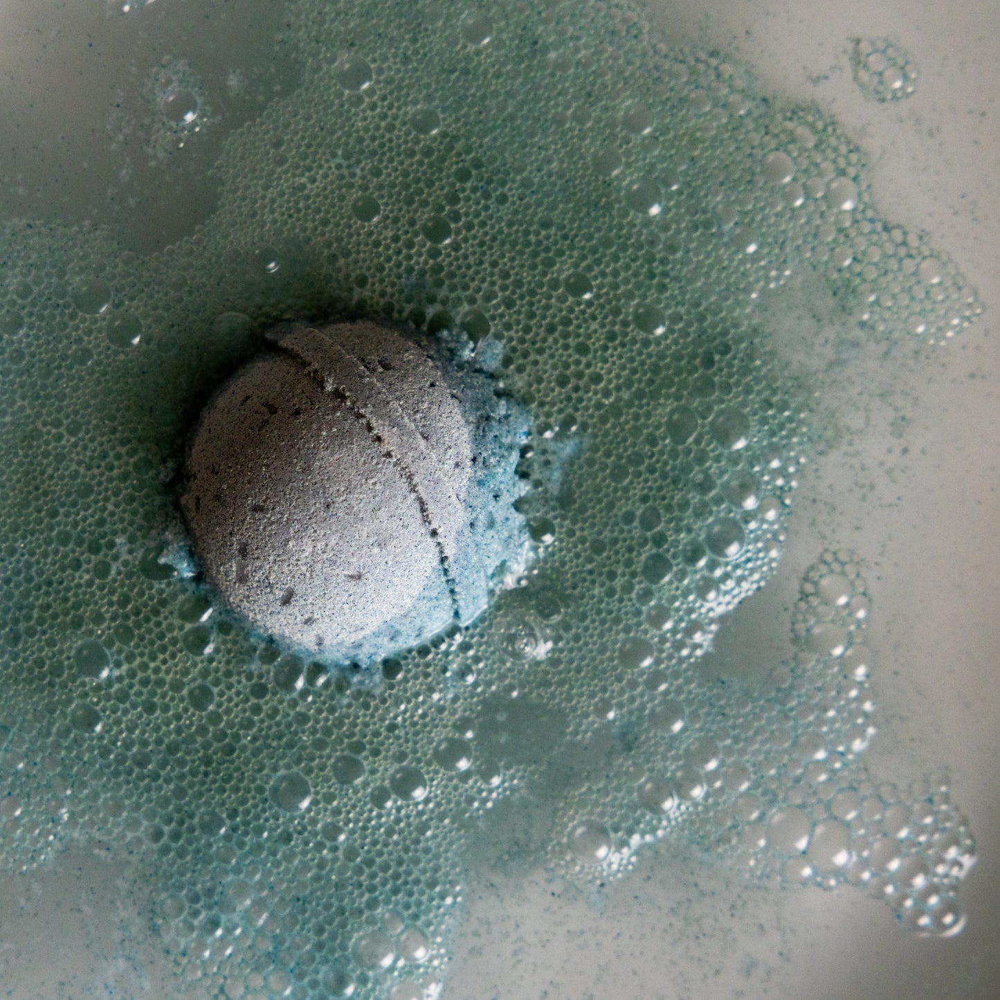 Bath bomb fizzing in water