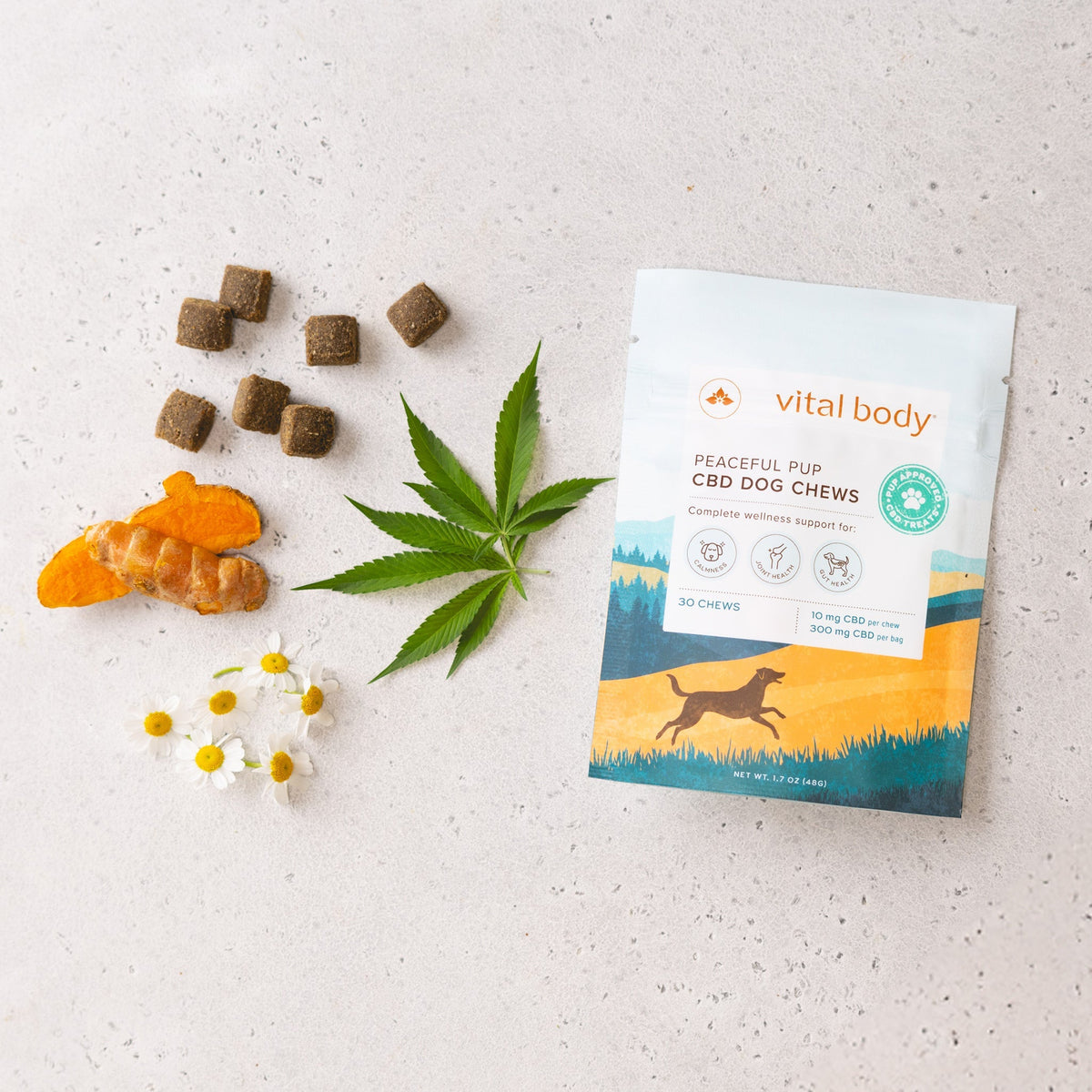 Vital Body CBD dog chews package with dog treats and a cannabis leaf on a light background
