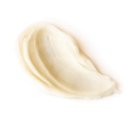 Close-up of a smooth swirl of beige cream on a white background