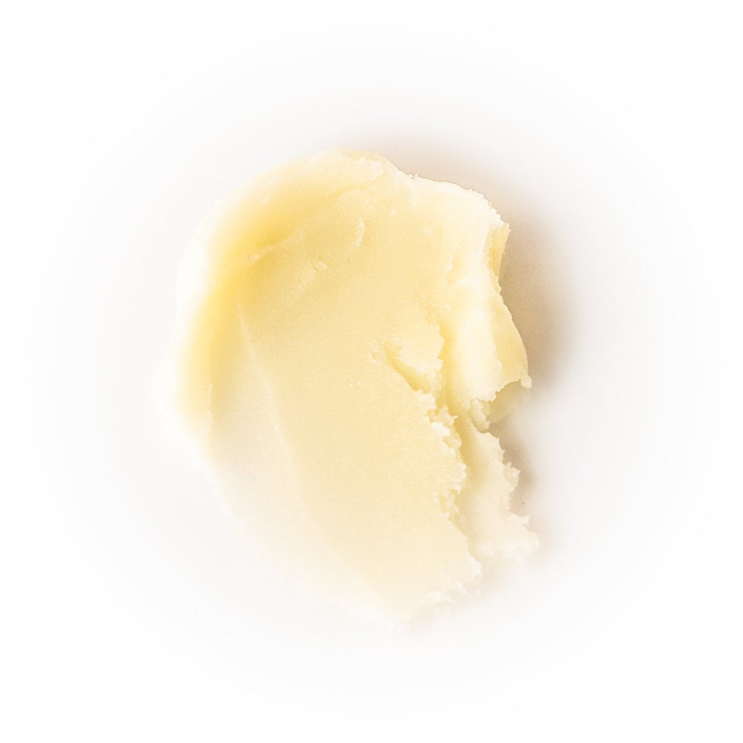 Close-up of a yellowish cream or paste on a white background