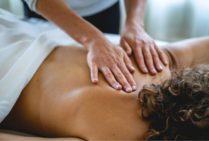 Person receiving a massage with hands on a blurred background